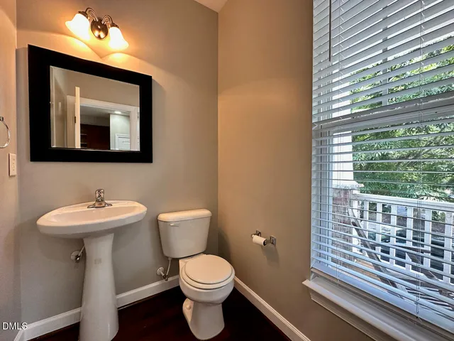 a bathroom with a toilet a sink and a mirror