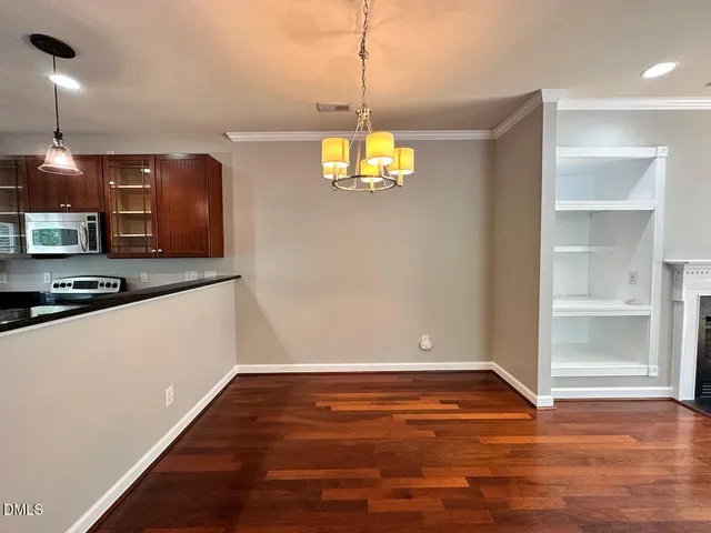 a view of a room with wooden floor and window