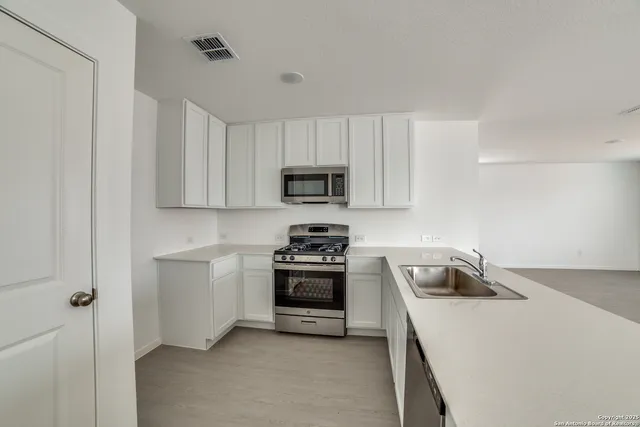 a kitchen with a stove and a microwave