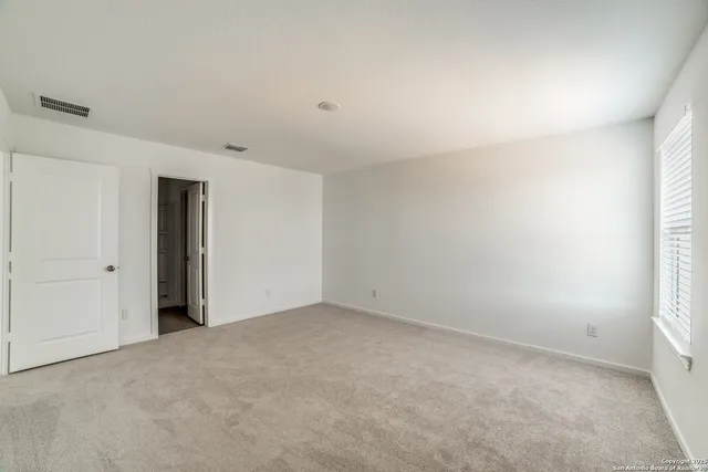a view of an empty room and closet