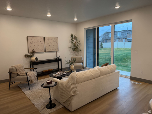 8087 South 615 East, Unit 3 Sandy, UT 84070 - Photo 5 of 23 Open-concept living area featuring wood-finish flooring, recessed lighting, and white baseboards