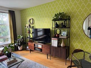 821 Folsom Street, Unit 217 San Francisco, CA 94107 - Photo 2 of 15 a living room with furniture and a flat screen tv