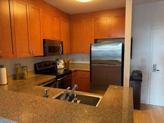 821 Folsom Street, Unit 217 San Francisco, CA 94107 - Photo 5 of 15 a kitchen with a refrigerator and a stove top oven