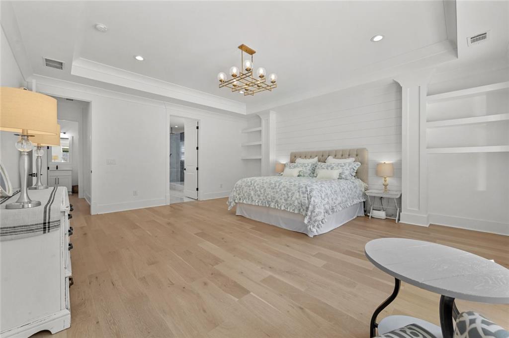 2694 Thompson Mill Road Buford, GA 30519 - Photo 37 of 70 a spacious bedroom with a bed and a chandelier