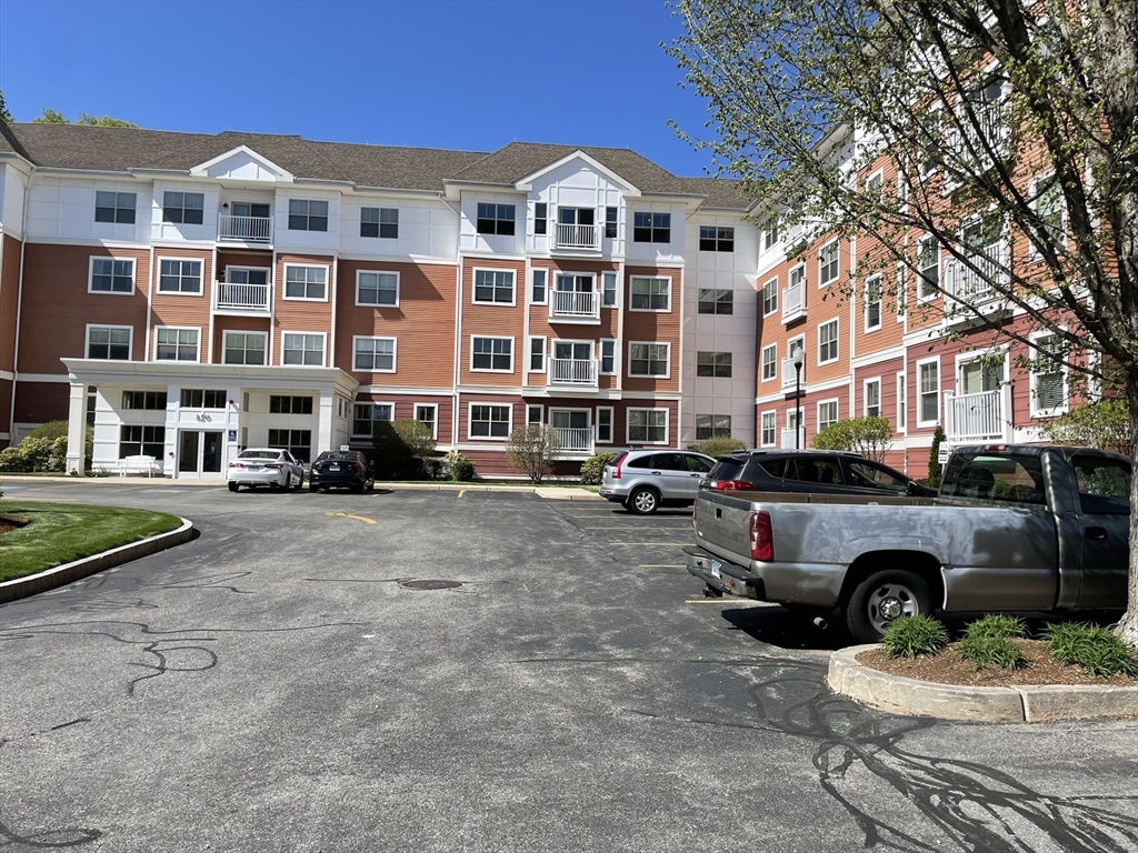 250 Main Street, Unit 317B Hudson, MA 01749 - Photo 1 of 10 a front view of a building with parking space