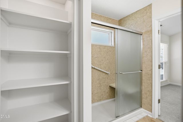 a bathroom with a glass shower door