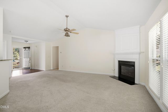 a view of an empty room with a fireplace