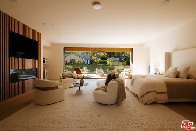 a living room with furniture and a floor to ceiling window