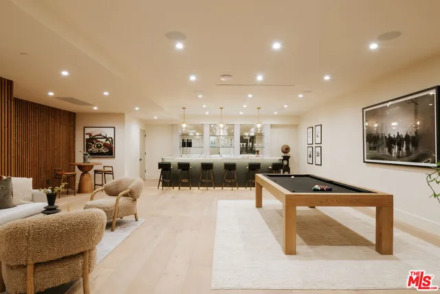 an aerial view of a house with a yard and large trees