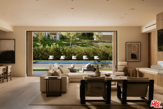 a dining hall with stainless steel appliances granite countertop a stove and a sink