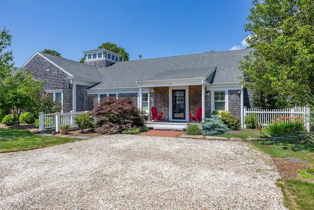 a view of a house with sitting area and garden