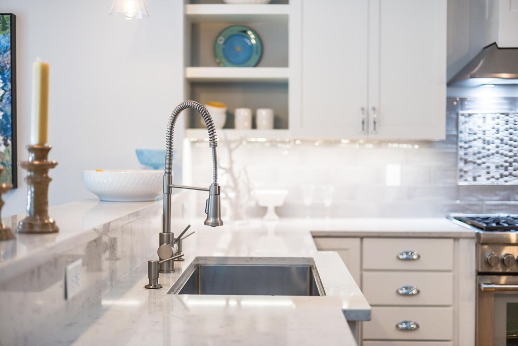 950 Massasoit Road, Unit 3 Eastham, MA 02642 - Photo 13 of 42 a kitchen with a sink and a stove with white countertops