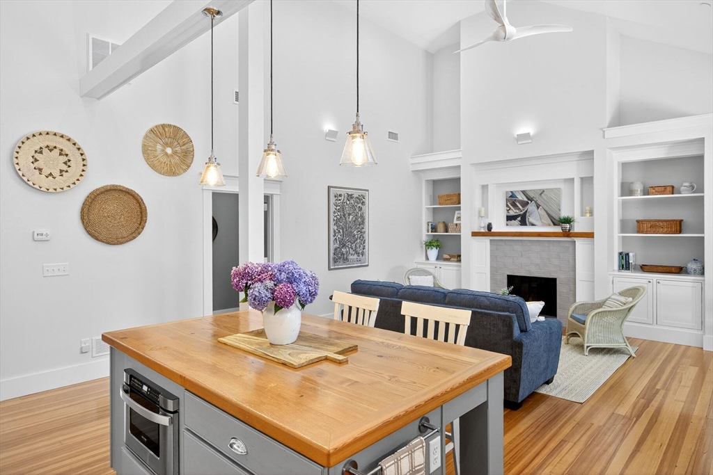 950 Massasoit Road, Unit 3 Eastham, MA 02642 - Photo 16 of 42 a view of a dining room with furniture wooden floor and chandelier