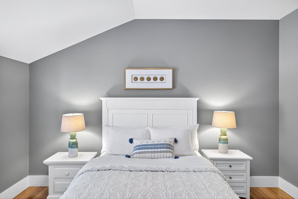 950 Massasoit Road, Unit 3 Eastham, MA 02642 - Photo 30 of 42 a bedroom with a bed and a lamp on table