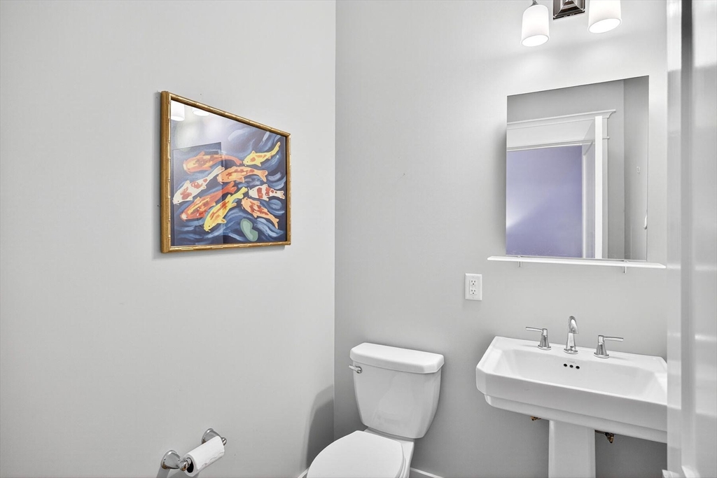 950 Massasoit Road, Unit 3 Eastham, MA 02642 - Photo 34 of 42 a bathroom with a toilet a sink and mirror