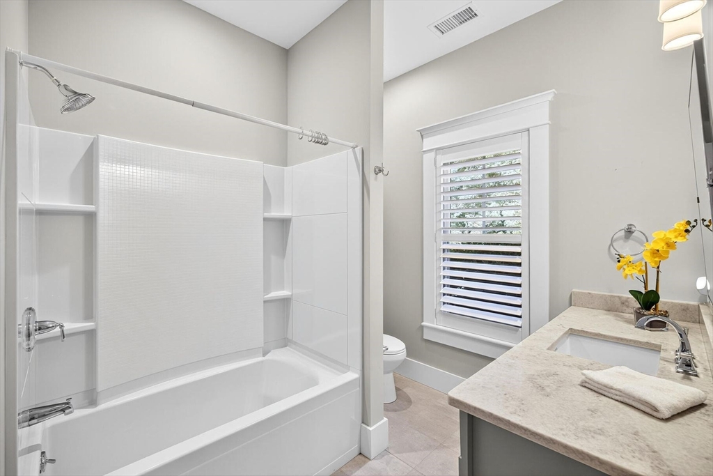 950 Massasoit Road, Unit 3 Eastham, MA 02642 - Photo 38 of 42 a bathroom with a granite countertop sink and a bathtub