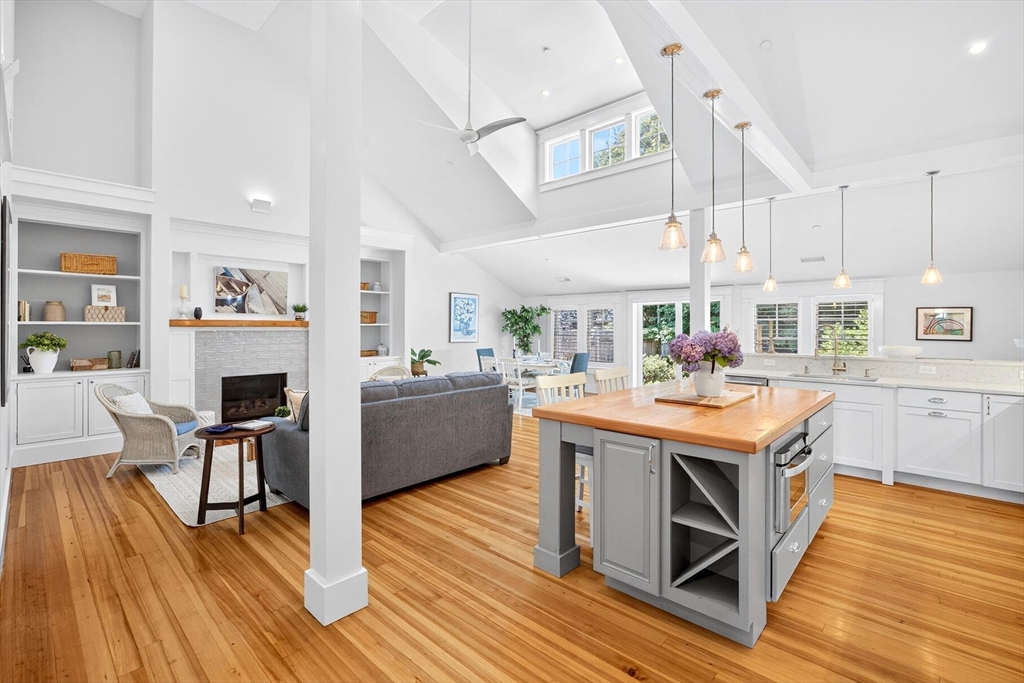 950 Massasoit Road, Unit 3 Eastham, MA 02642 - Photo 9 of 42 a living room with furniture a fireplace and wooden floor