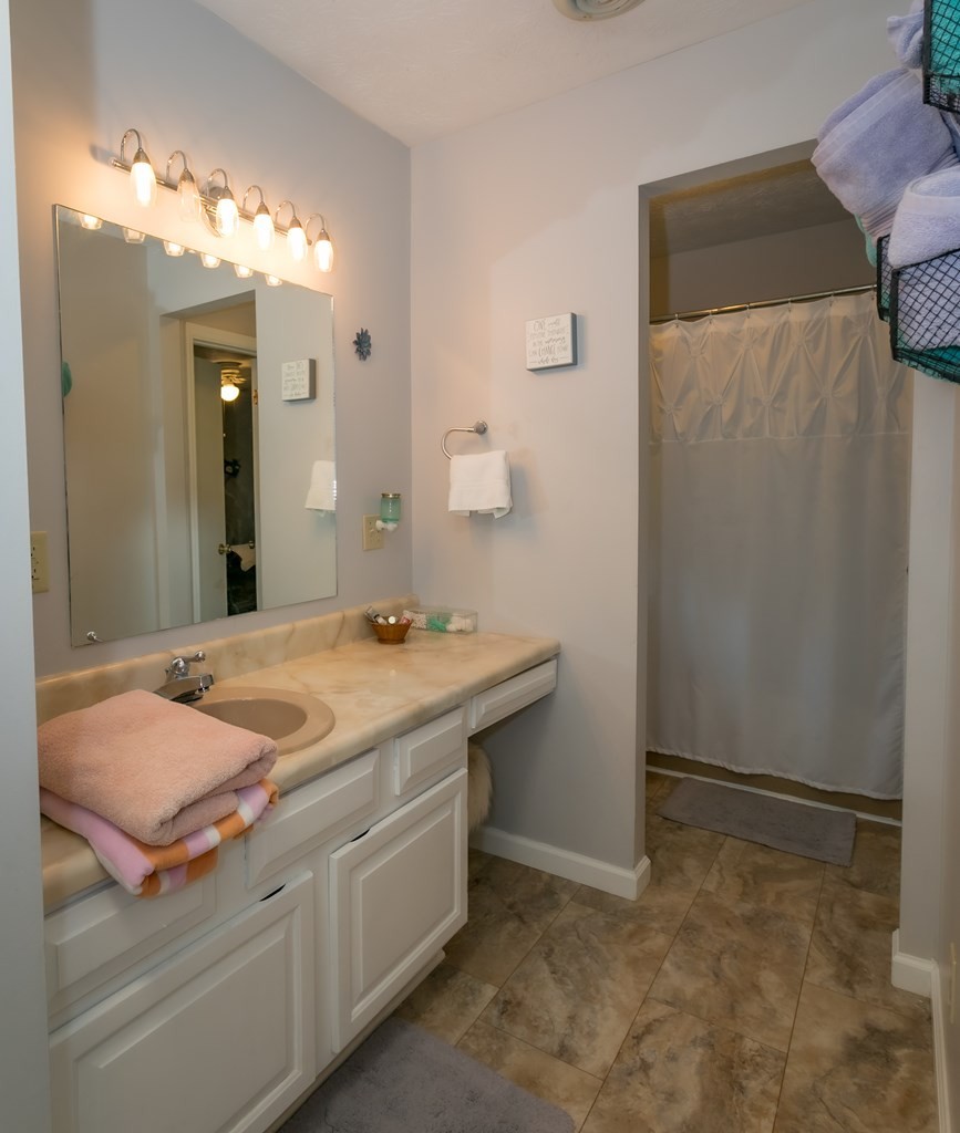 3108 Fortenberry Road Kodak, TN 37764 - Photo 18 of 47 a bathroom with a granite countertop sink and a mirror