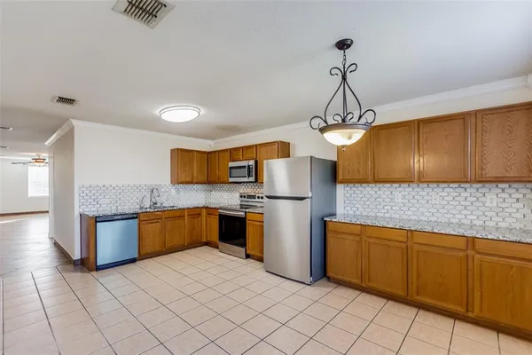 a kitchen with stainless steel appliances granite countertop a sink and dishwasher