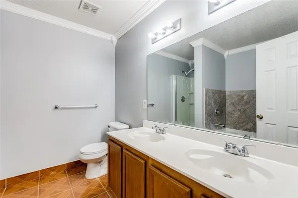 a bathroom with a sink mirror vanity and toilet