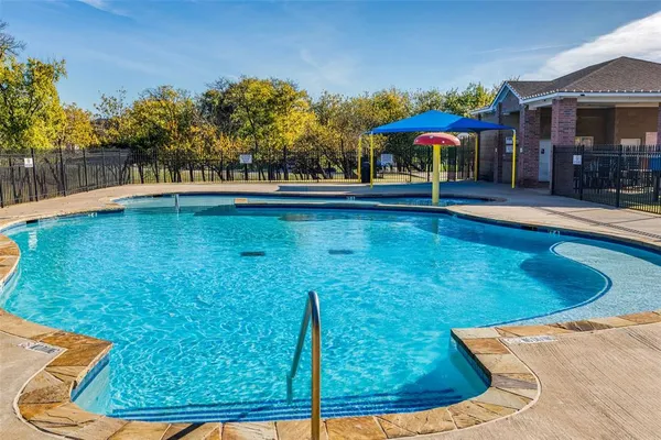 a view of a swimming pool with outdoor seating