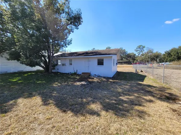 a view of a backyard with plants and lake view