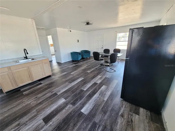 a bed room with furniture and mirror