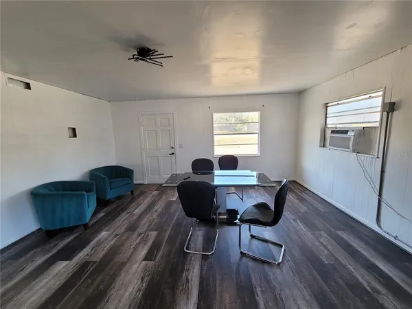 a work room with furniture and wooden floor