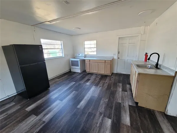 a kitchen with sink cabinets and wooden floor