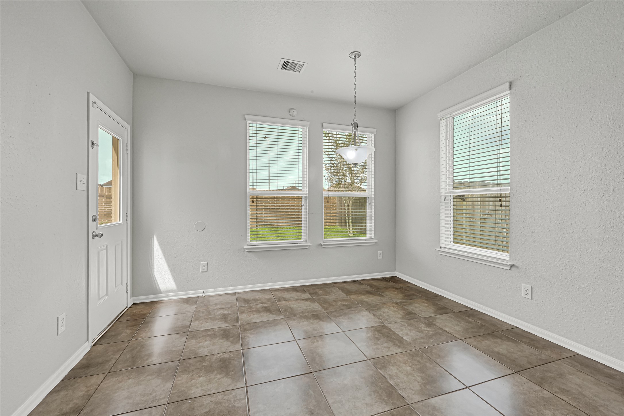 4702 Sedgewood Drive Rosenberg, TX 77471 - Photo 17 of 24 Breakfast area with large wall of windows and a door leading to back patio.