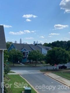 a view of a street with a big yard