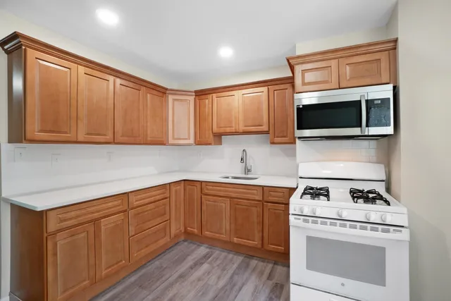 a kitchen with sink cabinets and stainless steel appliances