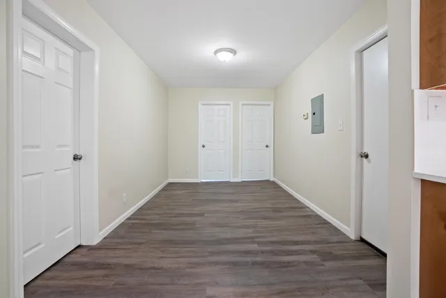 a view of a hallway with wooden floor