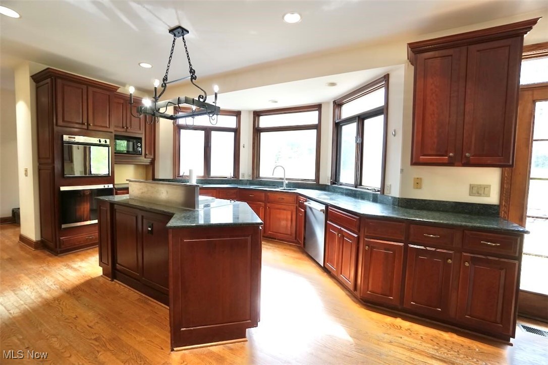 7060 Gates Road Gates Mills, OH 44040 - Photo 9 of 38 Kitchen featuring plenty of natural light, dark stone countertops, light wood-type flooring, a center island, and recessed lighting
