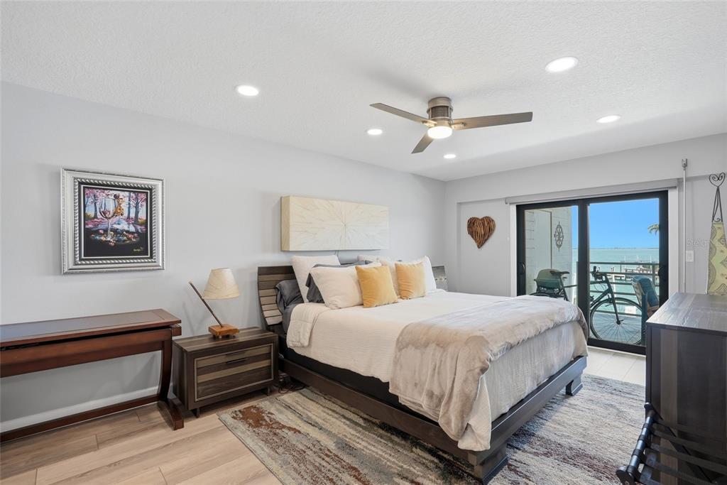 363 Pinellas Bayway South, Unit 29 Tierra Verde, FL 33715 - Photo 21 of 59 a bedroom with a large bed chandelier and a window