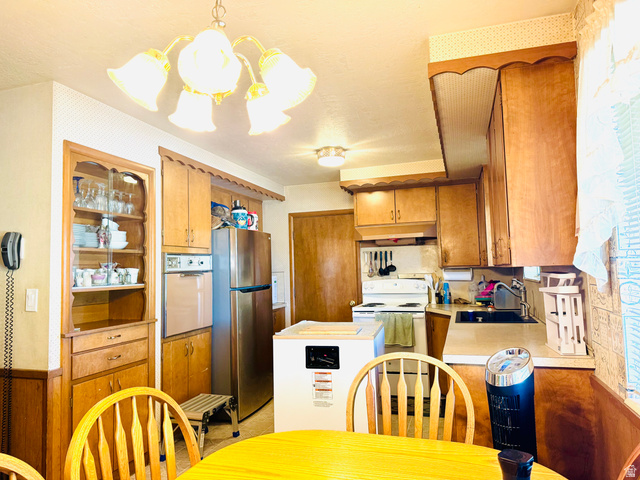 1611 South 75 East Bountiful, UT 84010 - Photo 11 of 23 Kitchen featuring wood cabinetry, built-in display hutch, wall oven, electric range, and a stainless steel refrigerator