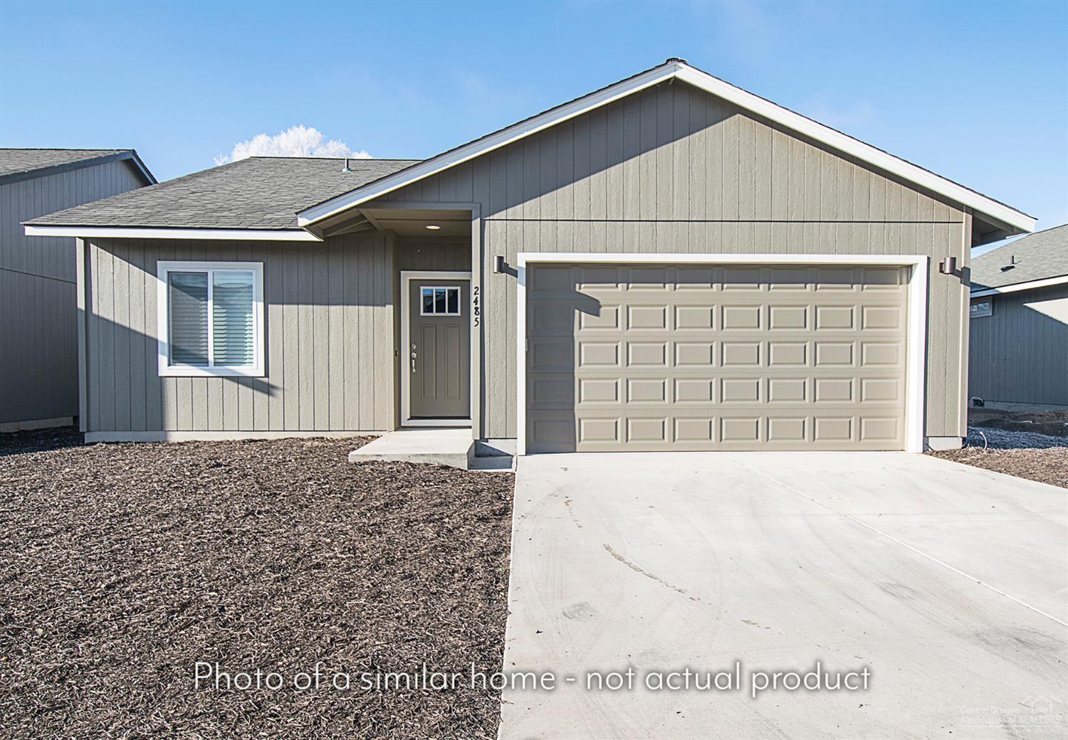 2547 Northeast Apollo Road Prineville, OR 97754 - Photo 9 of 9 a front view of a house with a yard and garage