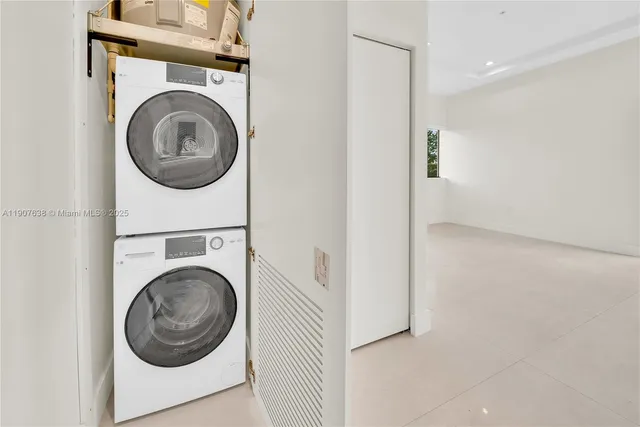 a view of a hallway with washer and dryer