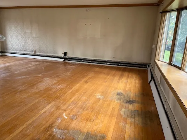 a view of a room with wooden floor