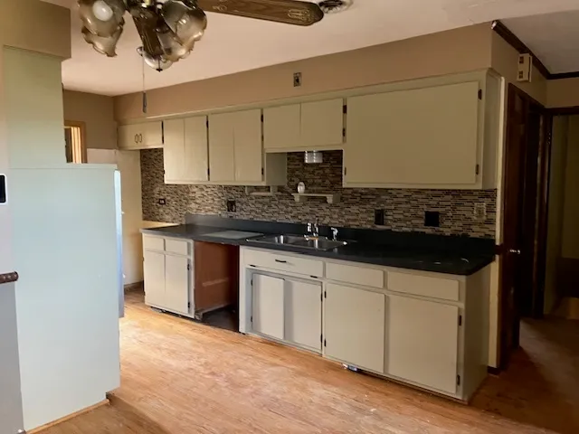 a kitchen with stainless steel appliances granite countertop a sink and cabinets