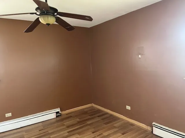 a view of a room with a fan and a ceiling fan