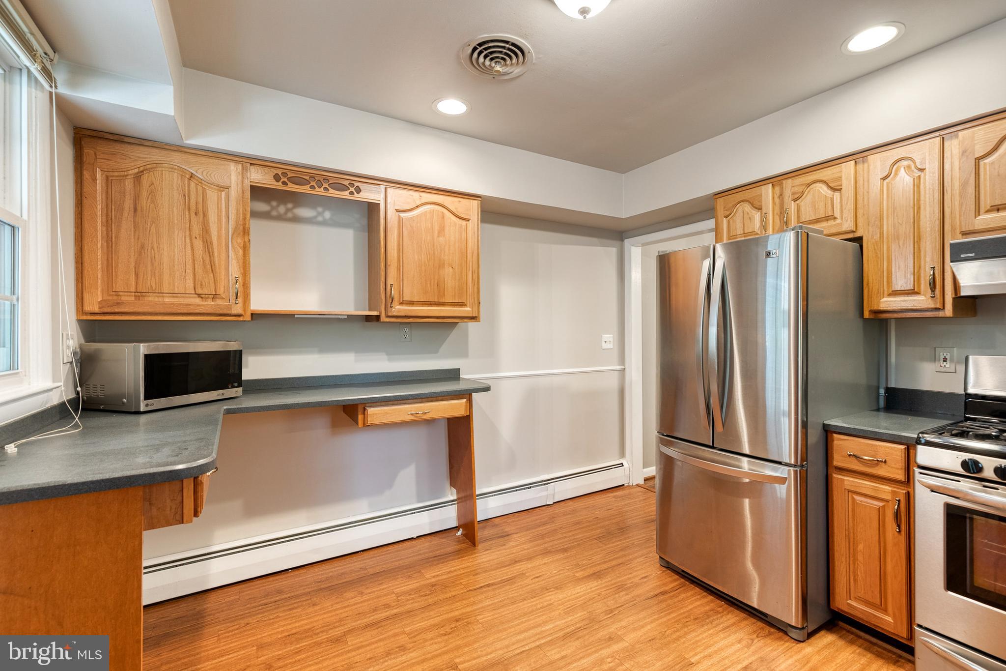 1022 Roxleigh Road Towson, MD 21286 - Photo 15 of 36 a kitchen with stainless steel appliances granite countertop a refrigerator microwave and sink