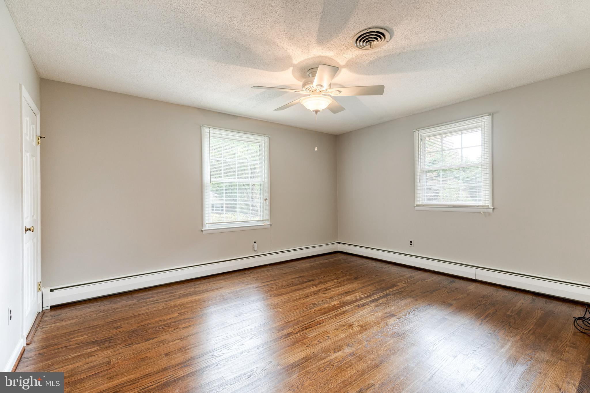 1022 Roxleigh Road Towson, MD 21286 - Photo 17 of 36 a view of an empty room with wooden floor and a window