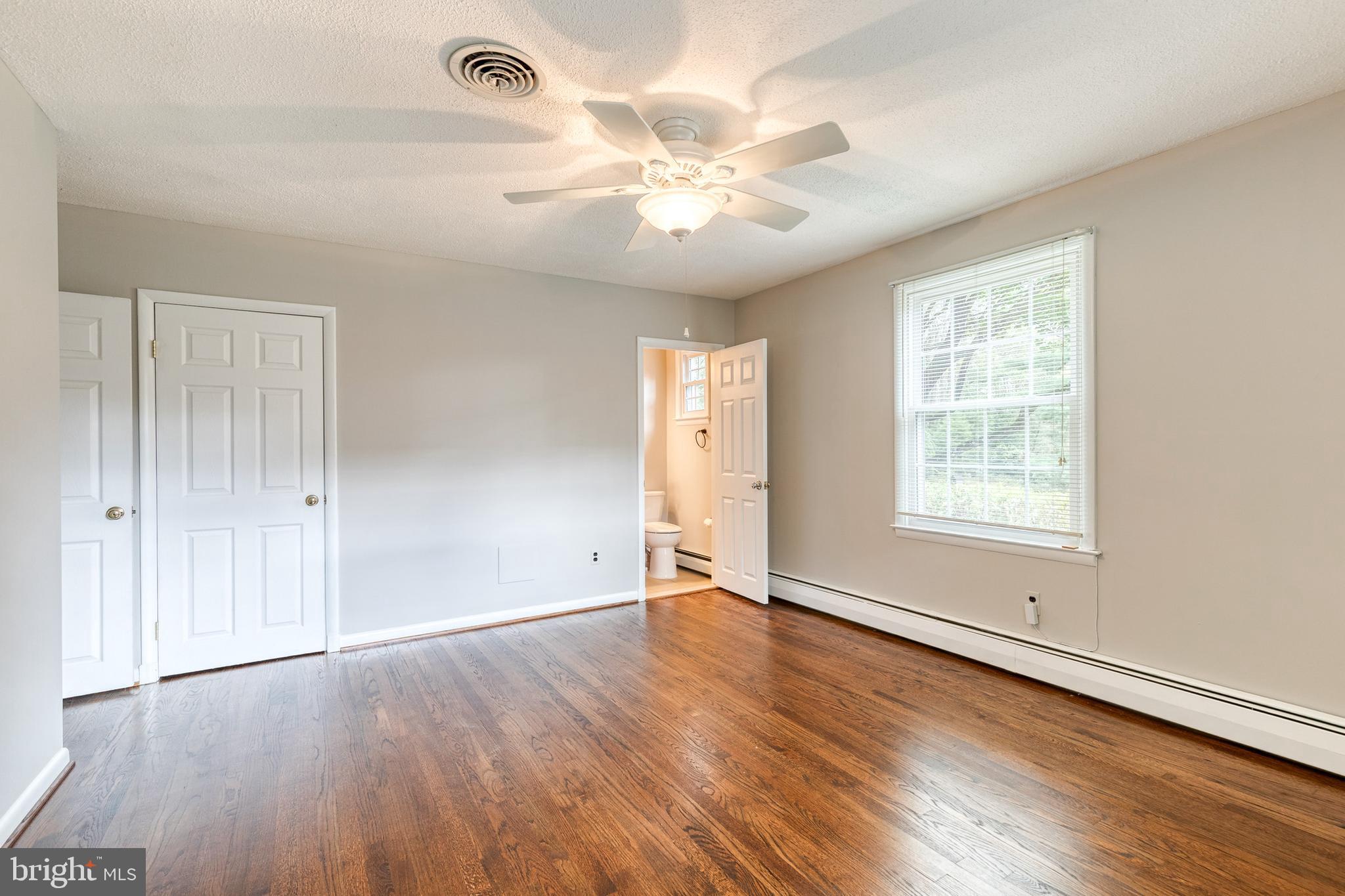 1022 Roxleigh Road Towson, MD 21286 - Photo 19 of 36 an empty room with wooden floor and windows