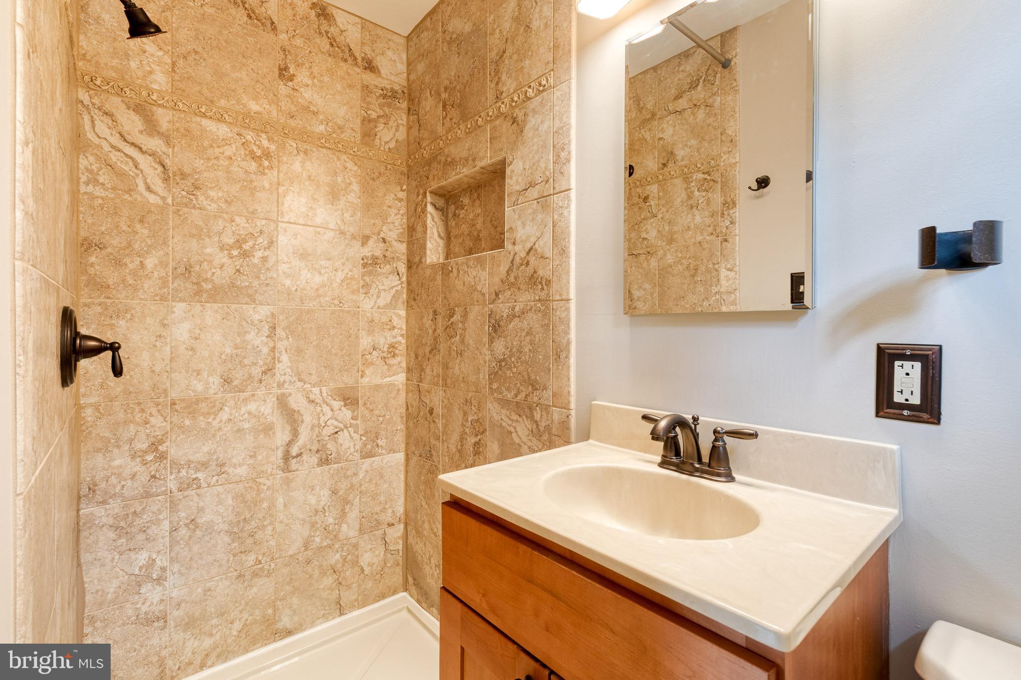 1022 Roxleigh Road Towson, MD 21286 - Photo 20 of 36 a bathroom with a sink toilet and shower