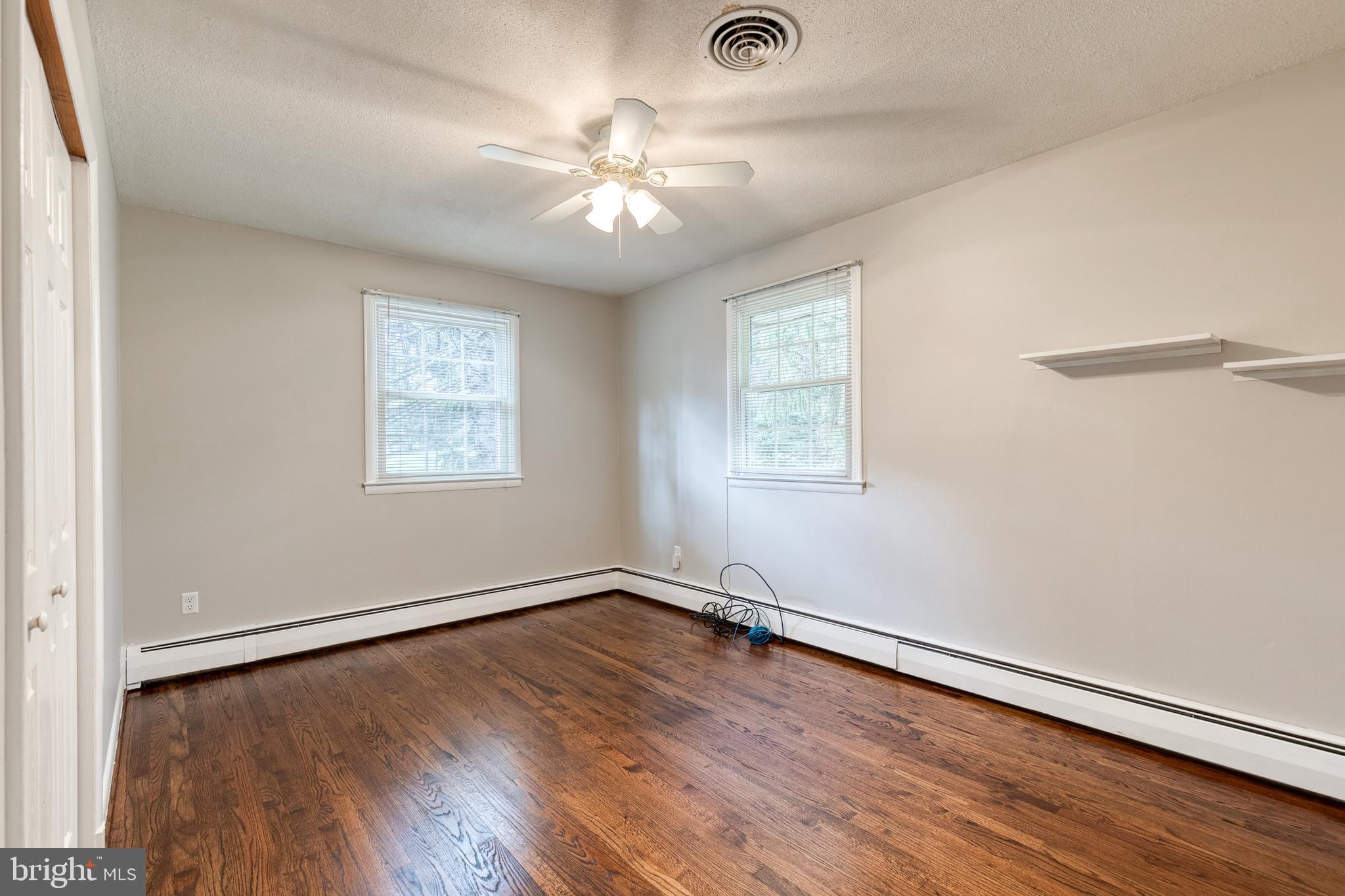 1022 Roxleigh Road Towson, MD 21286 - Photo 21 of 36 a view of an empty room with wooden floor and a window