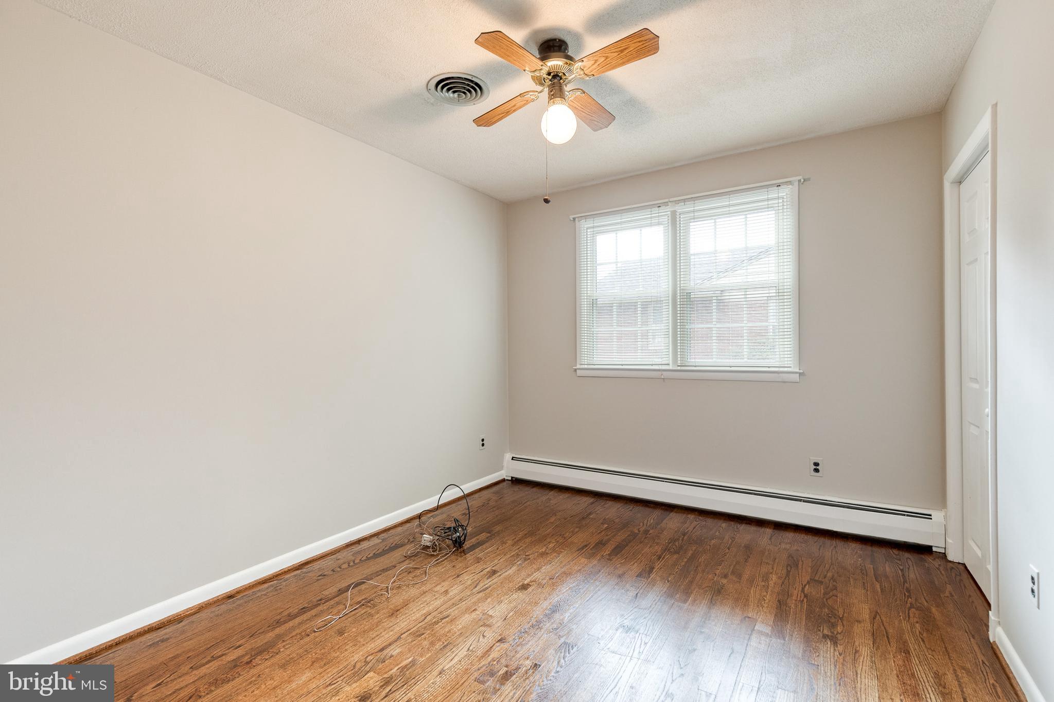 1022 Roxleigh Road Towson, MD 21286 - Photo 22 of 36 an empty room with wooden floor and windows