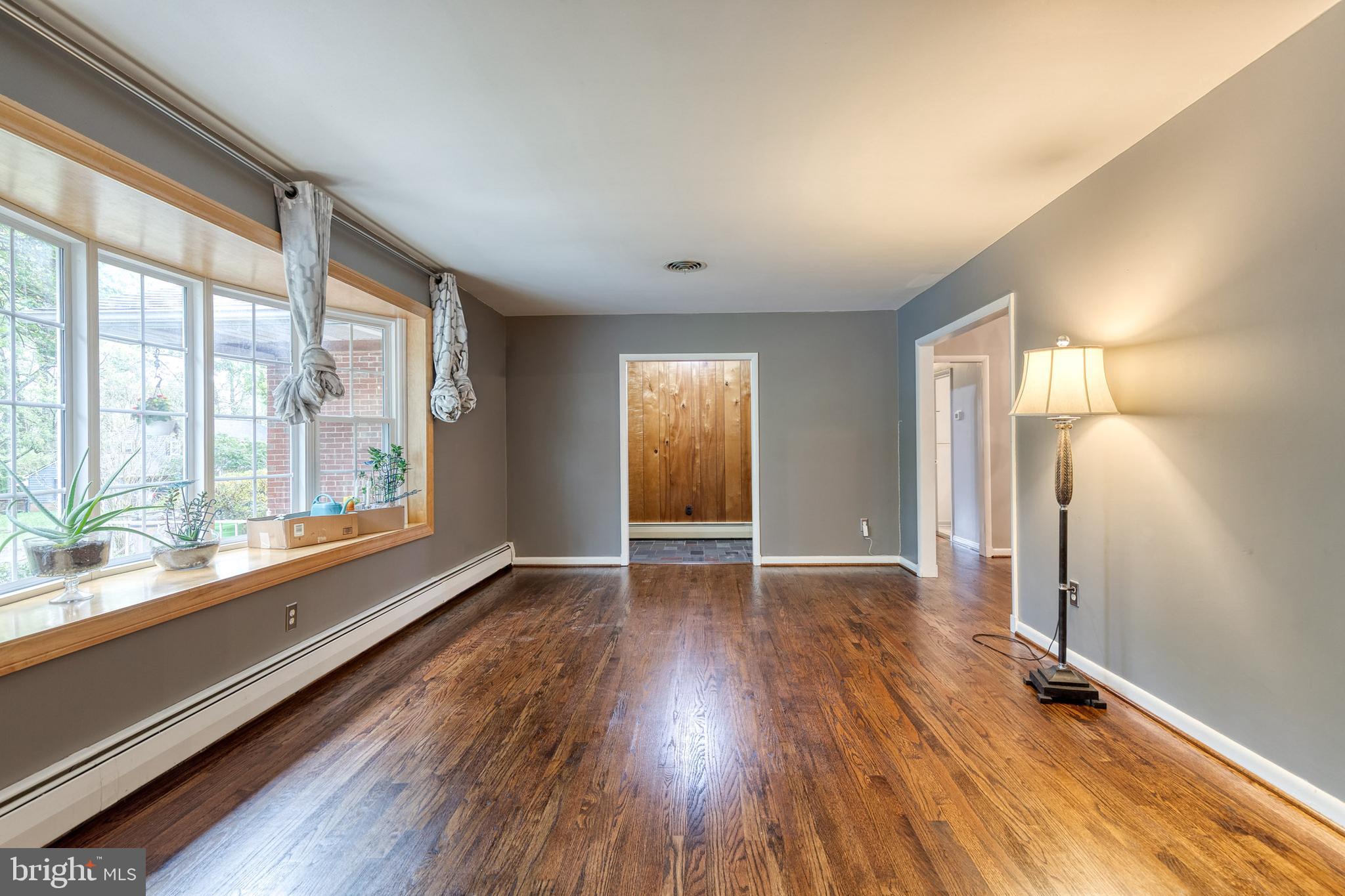 1022 Roxleigh Road Towson, MD 21286 - Photo 7 of 36 a view of an empty room with window and wooden floor