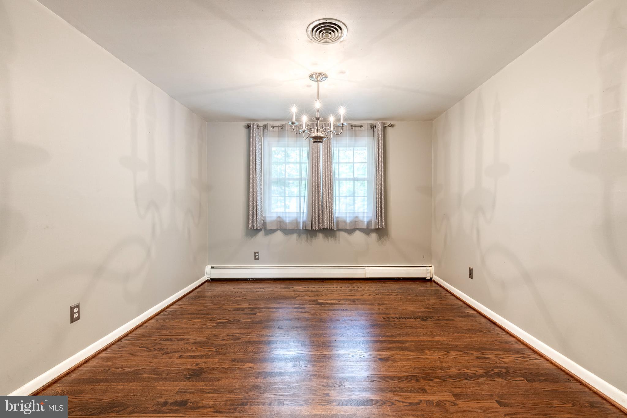 1022 Roxleigh Road Towson, MD 21286 - Photo 9 of 36 wooden floor in an empty room with a window