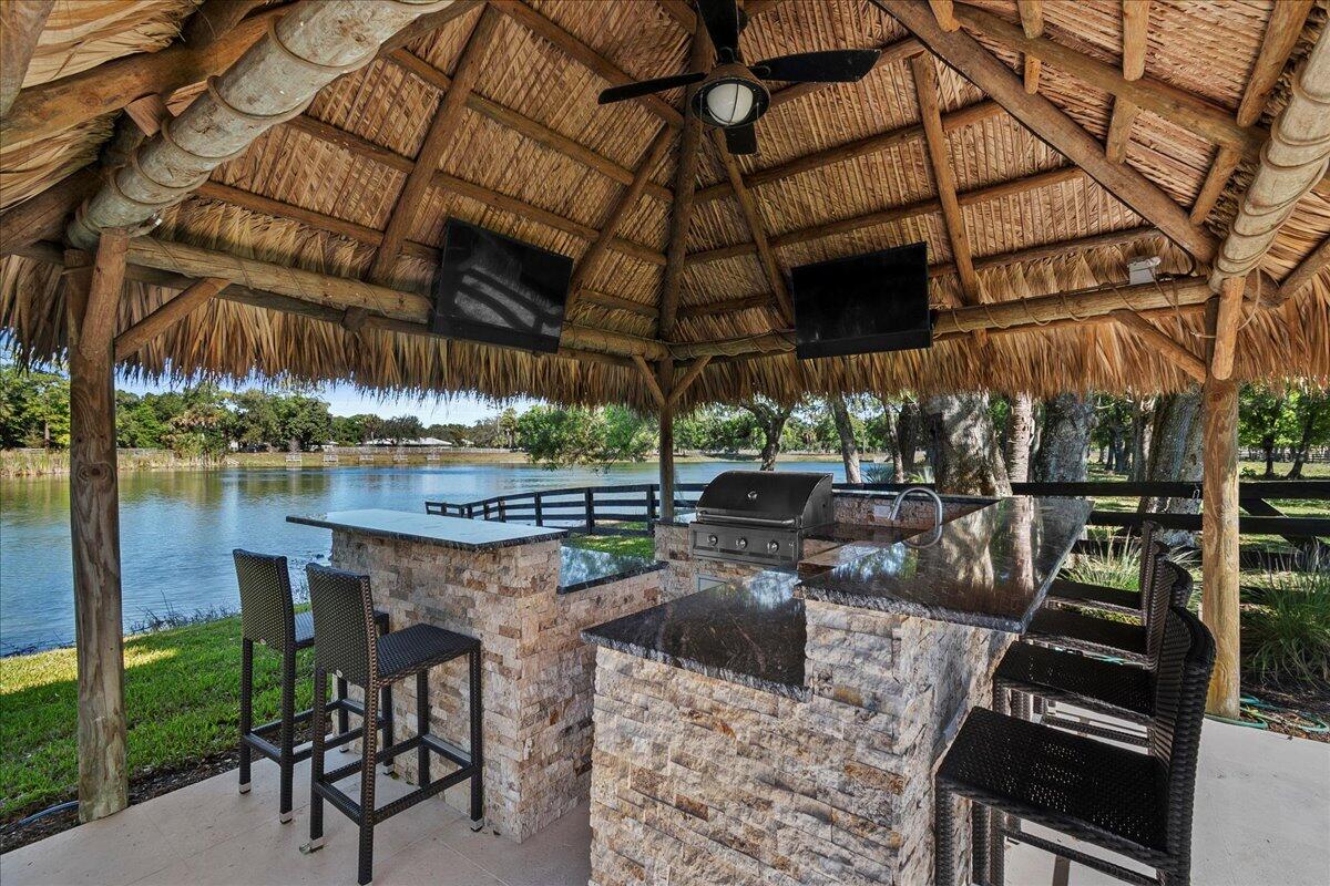 10975 Randolph Siding Road Jupiter, FL 33478 - Photo 59 of 97 a view of a chairs and table in the patio